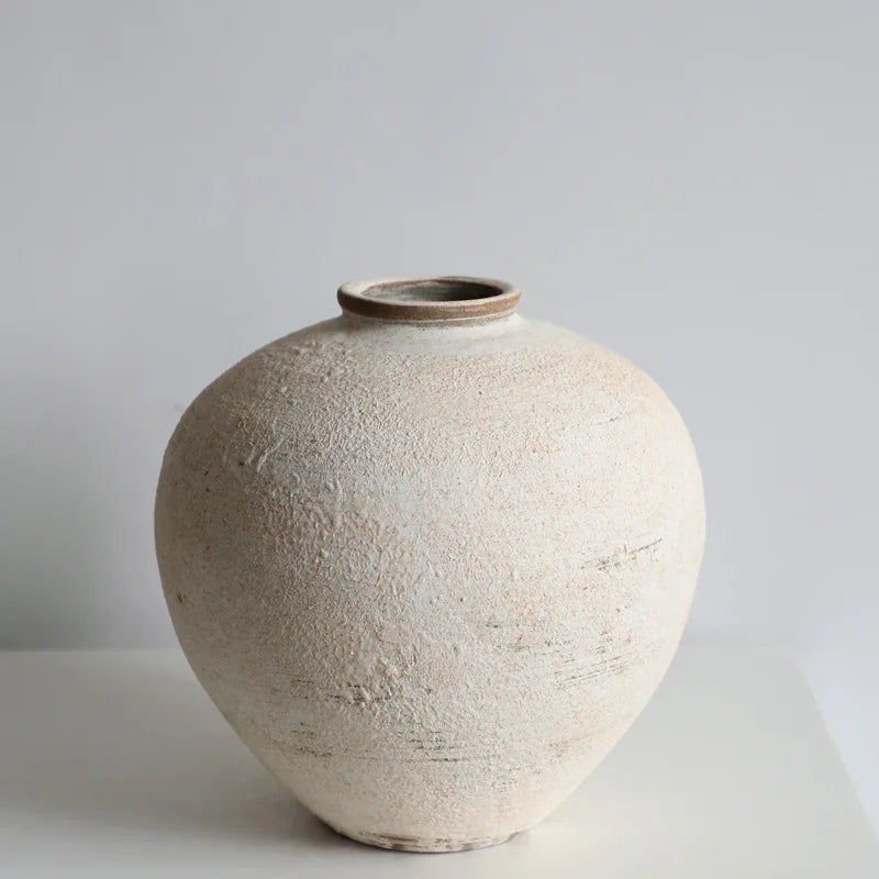 Textured ceramic vase on a light gray background
