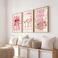 Three framed prints on a wall above a sofa with decorative pillows and a woven basket.