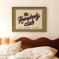 Framed artwork with 'the Homebody Club' text above a bed.