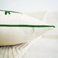 Close-up of a white pillow with green stitching on a white background