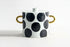 Ceramic pot with black polka dots and gold handles, shown with measurements on a white background.
