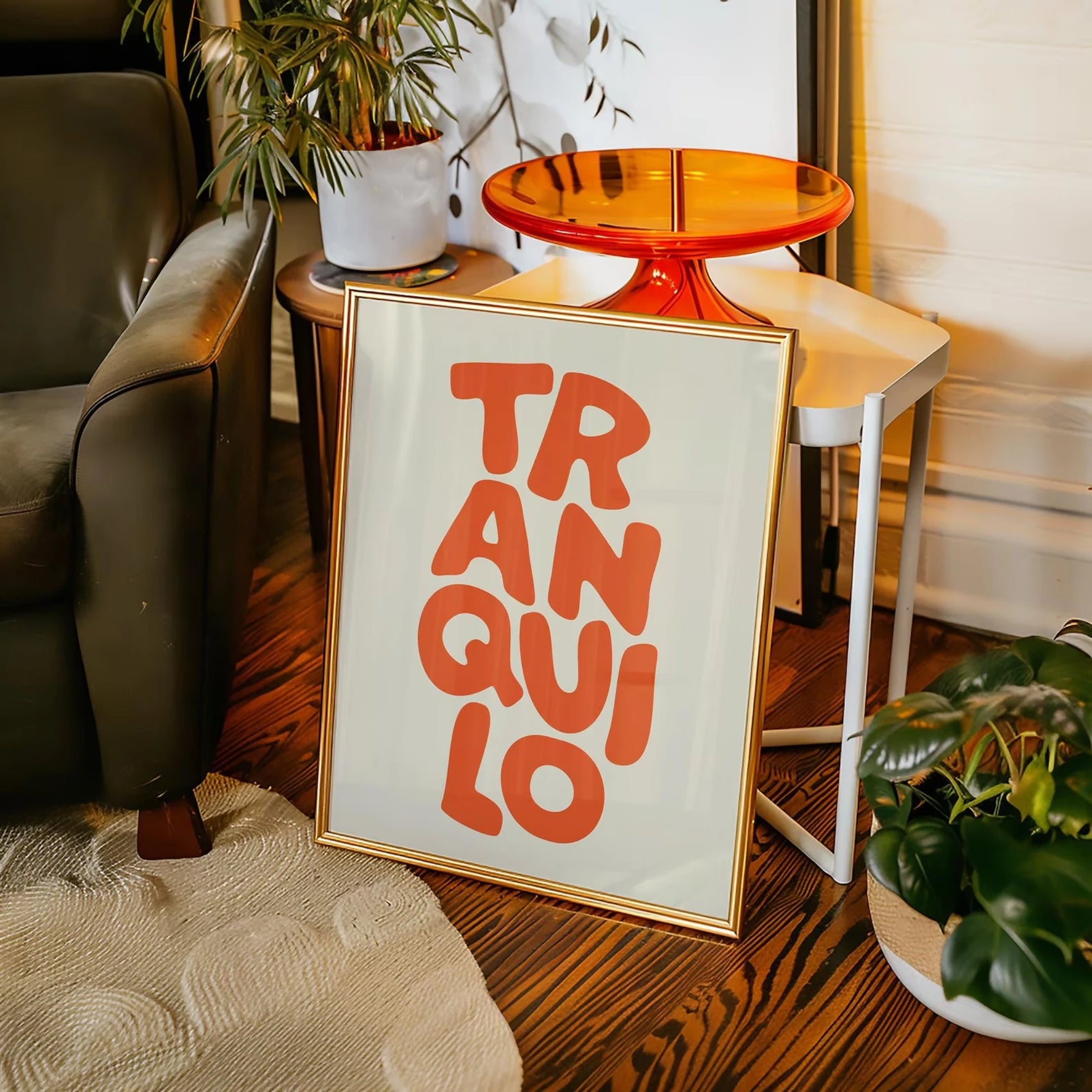 Framed artwork with 'TRANQUILO' text in a living room setting