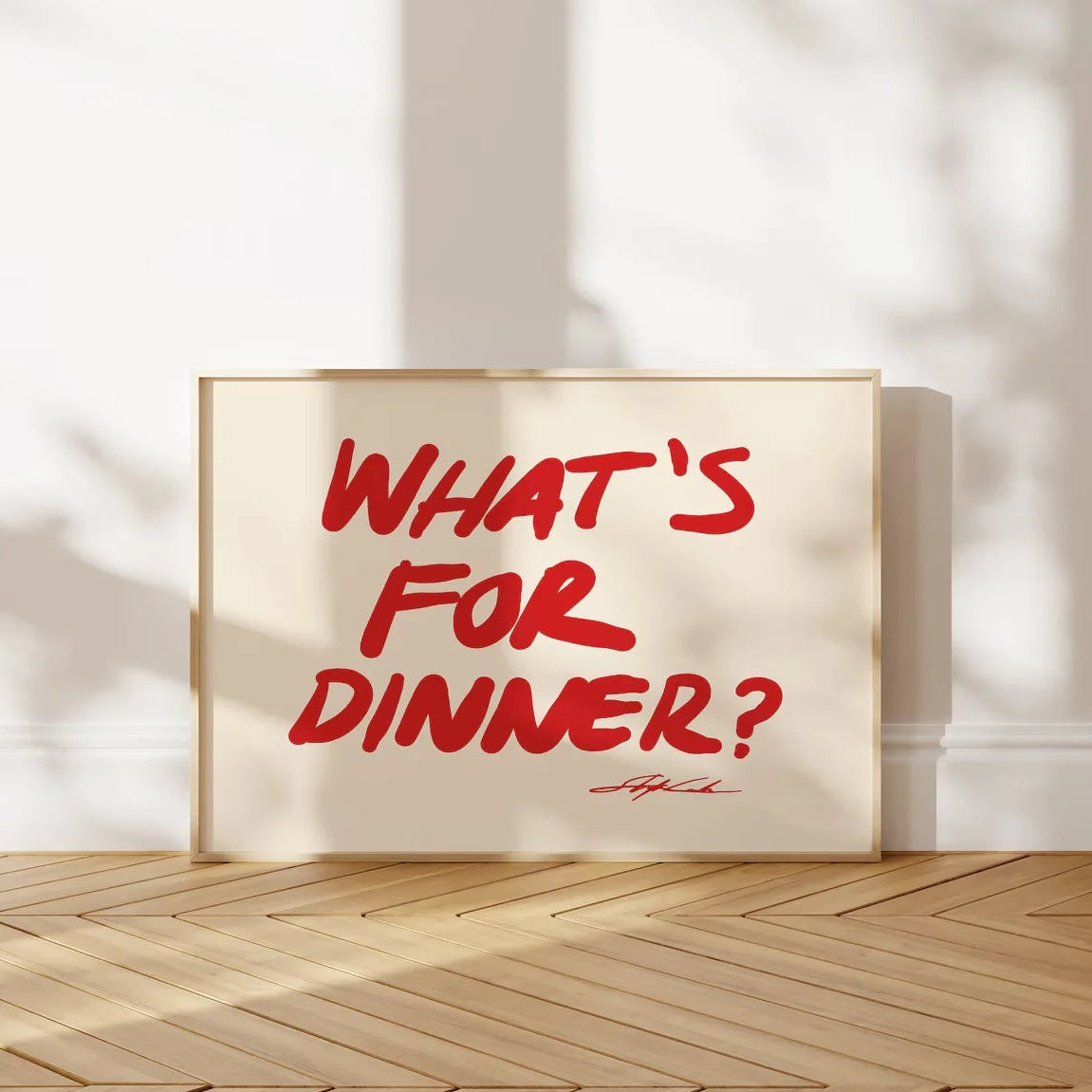 Poster with 'What's for Dinner?' text on a wall with sunlight casting shadows.