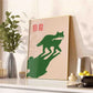 Framed artwork of a green cat on a beige background in a modern kitchen setting.