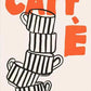 Stack of black and white striped coffee cups with 'CAFFÓ' text in orange on a beige background