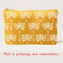 Yellow pouch with palm tree pattern on a white background
