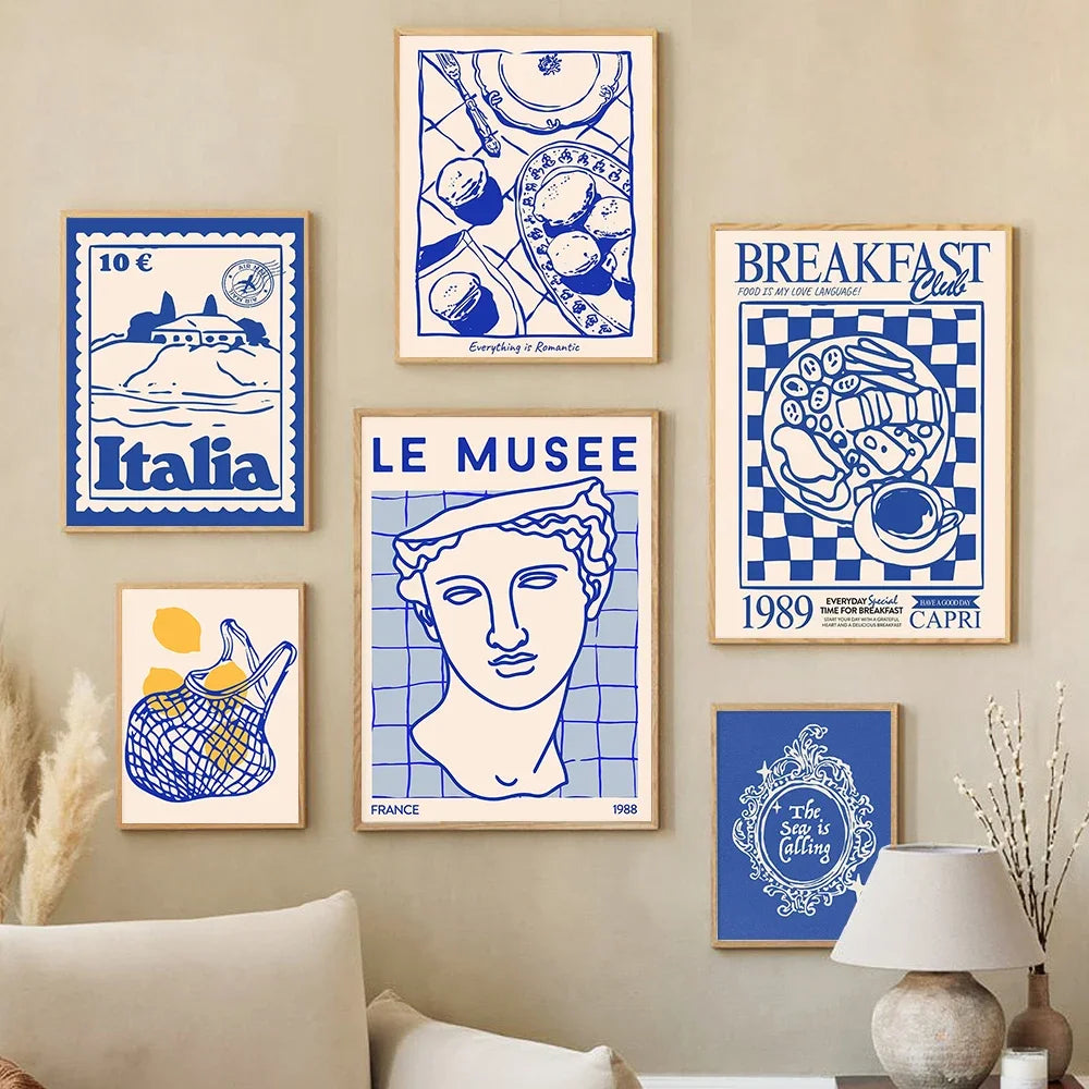 Collection of framed posters on a wall with a neutral color scheme.