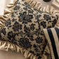 Decorative pillow with floral pattern on a beige surface