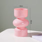 Pink vase with measurements on a gray background