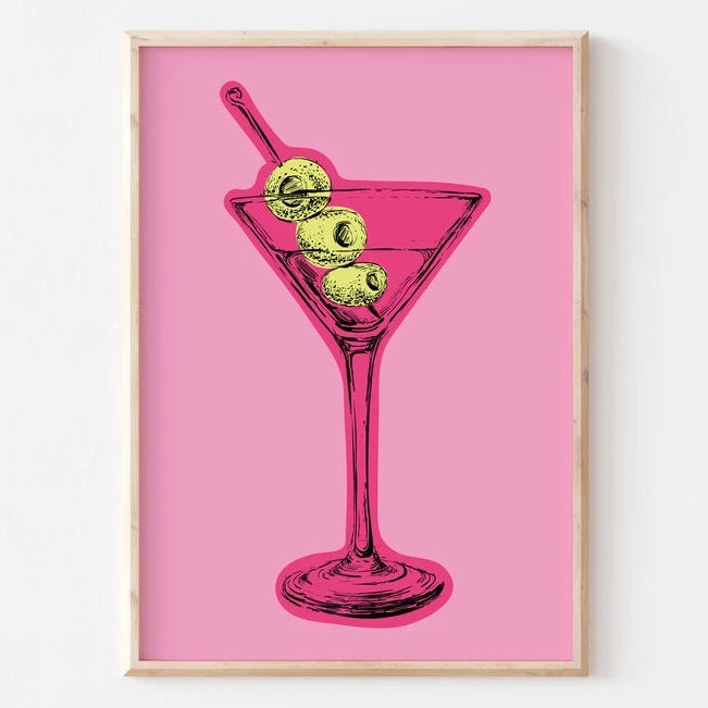 Framed artwork of a martini glass with olives on a pink background