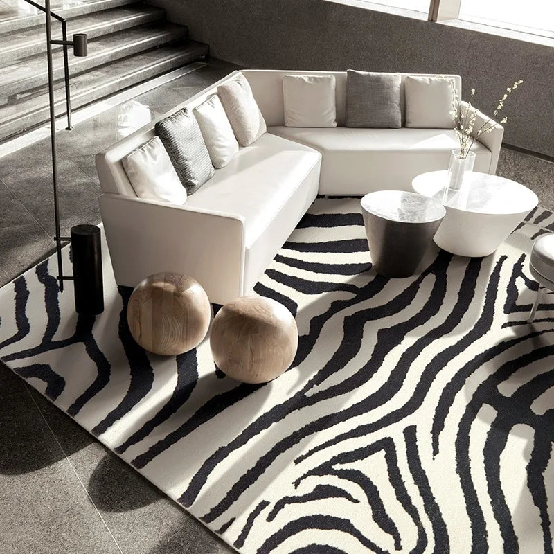 Modern living room with a zebra-patterned rug, white sofa, and decorative items.