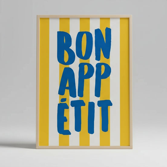 Framed artwork with 'Bon Appétit' text on a yellow and white striped background