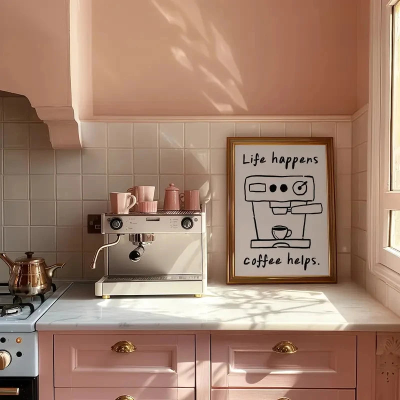 Kitchen with pink cabinets, espresso machine, and framed picture on the wall.