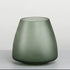 Green glass vase on a light gray background