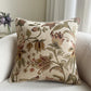 Floral-patterned pillow on a couch with a neutral background
