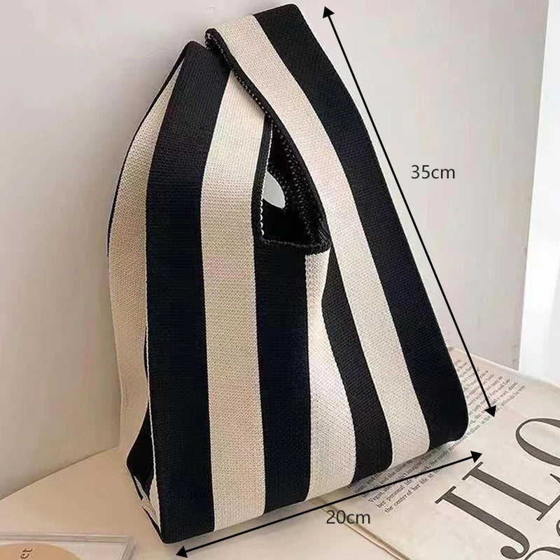 Black and white striped bag with measurements on a light surface