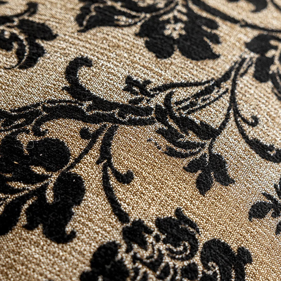 Close-up of a black floral pattern on a beige fabric surface