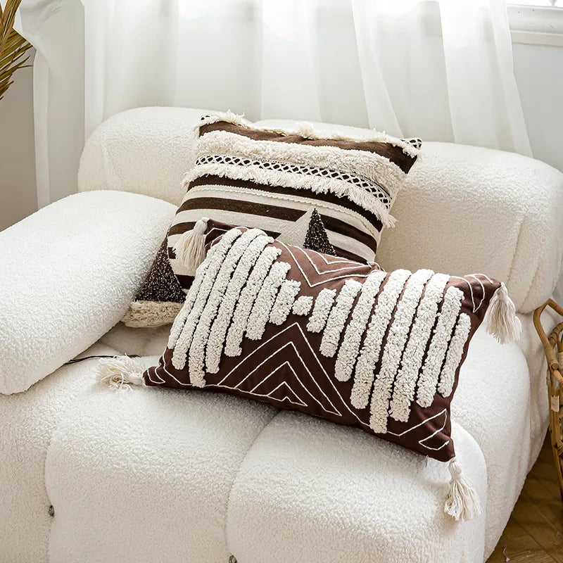Decorative pillows with tribal patterns on a white sofa