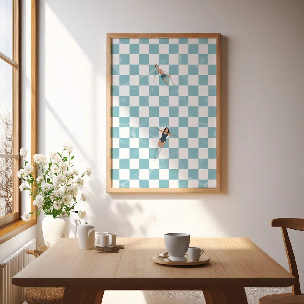 Framed checkered artwork above a wooden table with coffee cups and a vase.