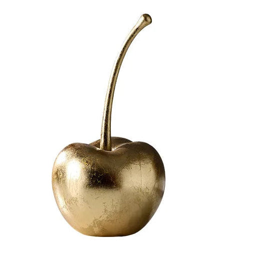 Gold cherry decorative item on a white background