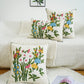Decorative pillows with floral patterns on a white couch.