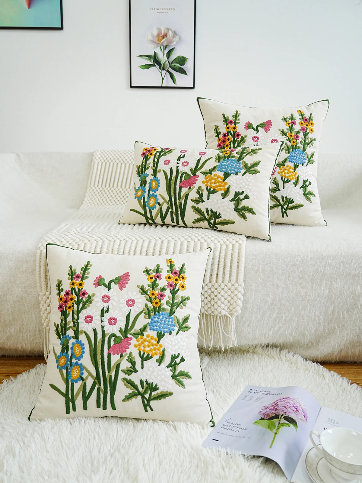 Decorative pillows with floral patterns on a white couch.