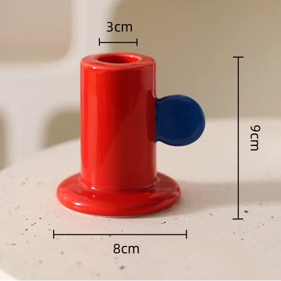 Red and blue cylindrical object with measurements on a light background