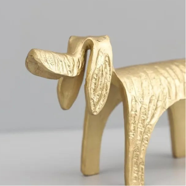 Gold dog-shaped object on a gray background