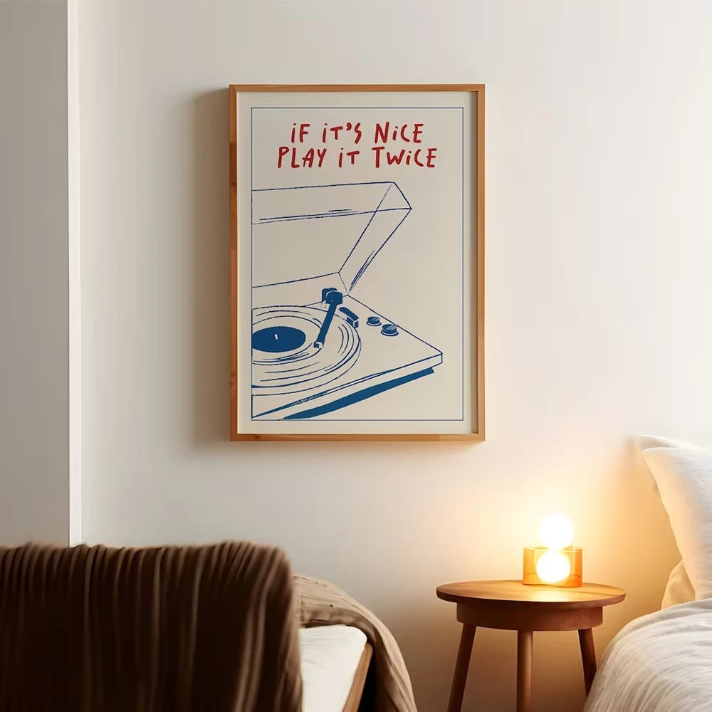 Framed artwork with a record player illustration and text in a bedroom setting.