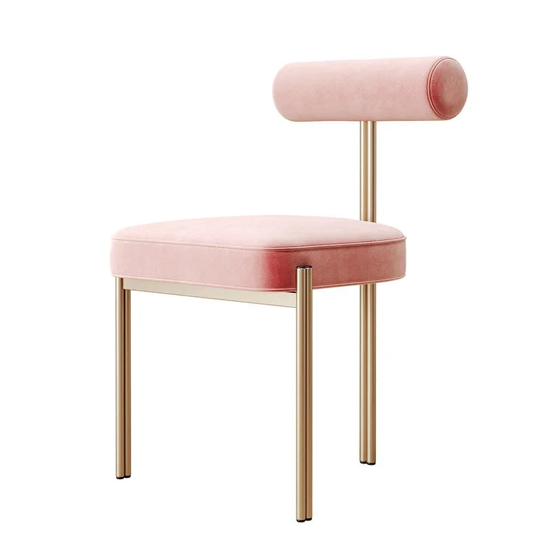A modern style dining chair with a pink backrest and seat, gold-colored legs, and no armrests.