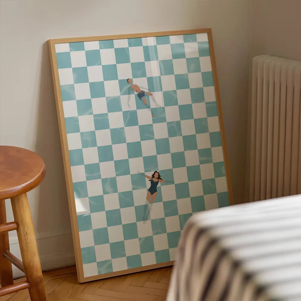 Framed artwork with a checkered pattern and two people lying on it, leaning against a wall.
