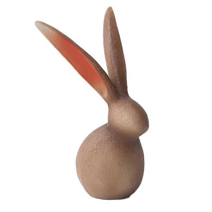Wooden rabbit figurine on a white background