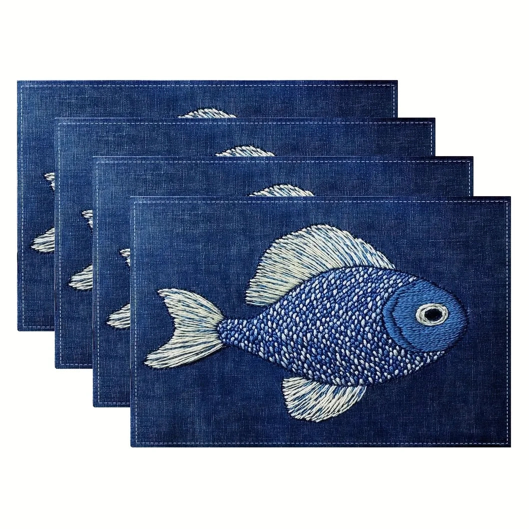 Set of four blue placemats with fish designs on a white background