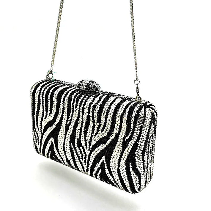 Zebra print clutch bag with a chain strap on a white background