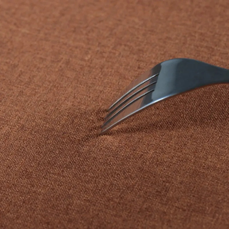 Metallic fork on a brown textured surface