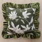 Decorative pillow with floral pattern and green ruffled edge on a beige background