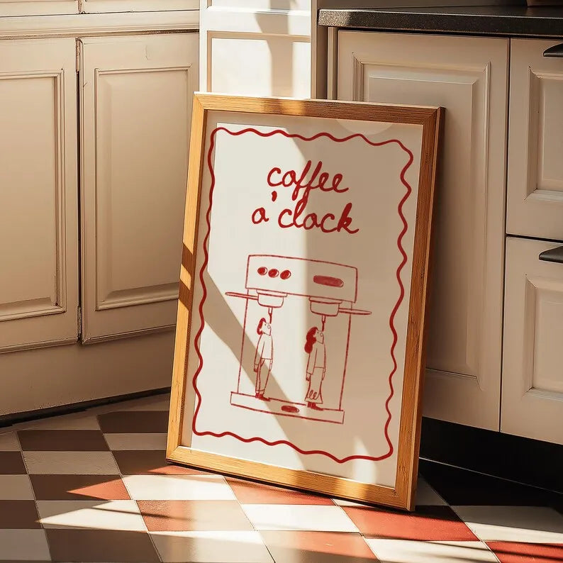 Framed artwork with 'coffee o'clock' text in a kitchen setting