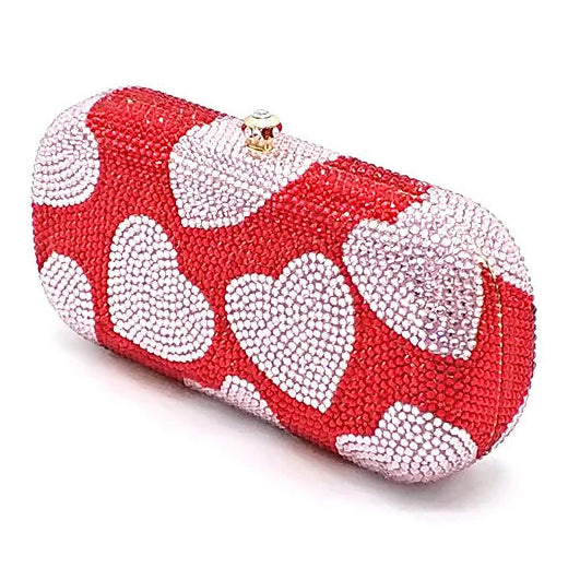 Red clutch with white heart patterns on a white background