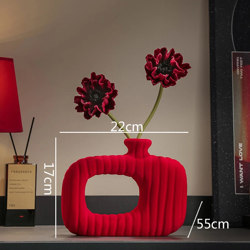 Red textured vase with flowers on a shelf, showing dimensions.