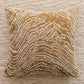 Decorative pillow with brown and beige pattern on a textured surface