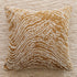 Decorative pillow with brown and beige pattern on a textured surface