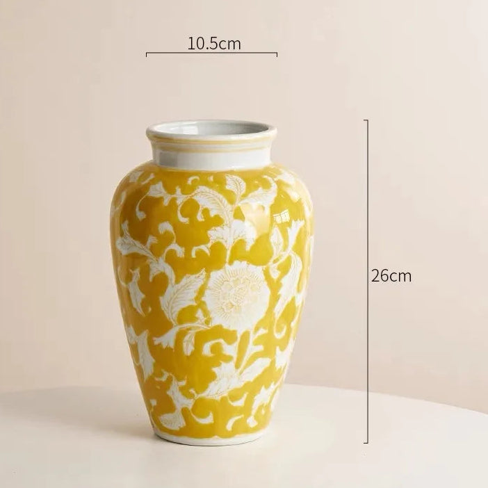 Yellow vase with white floral patterns and measurements on a beige background