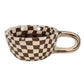 Checkered ceramic cup with a handle on a white background