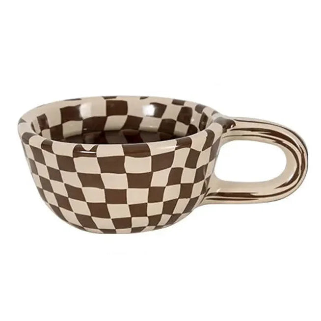 Checkered ceramic cup with a handle on a white background