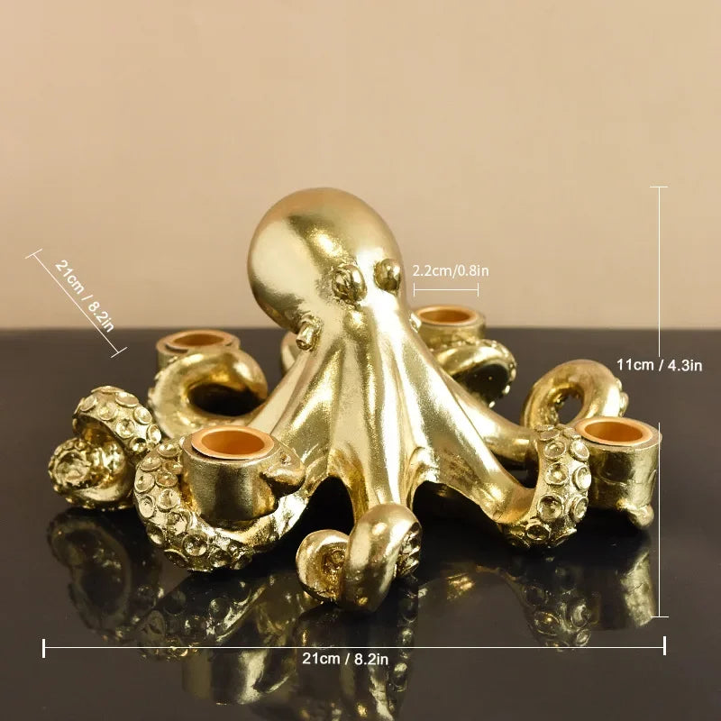 Gold octopus candle holder with measurements on a reflective surface