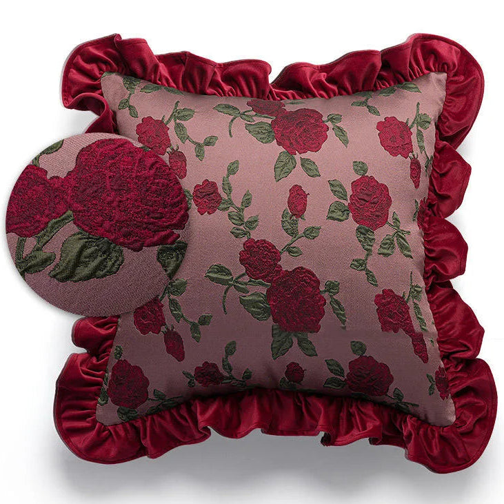 Decorative pillow with floral pattern and ruffled edges on a white background