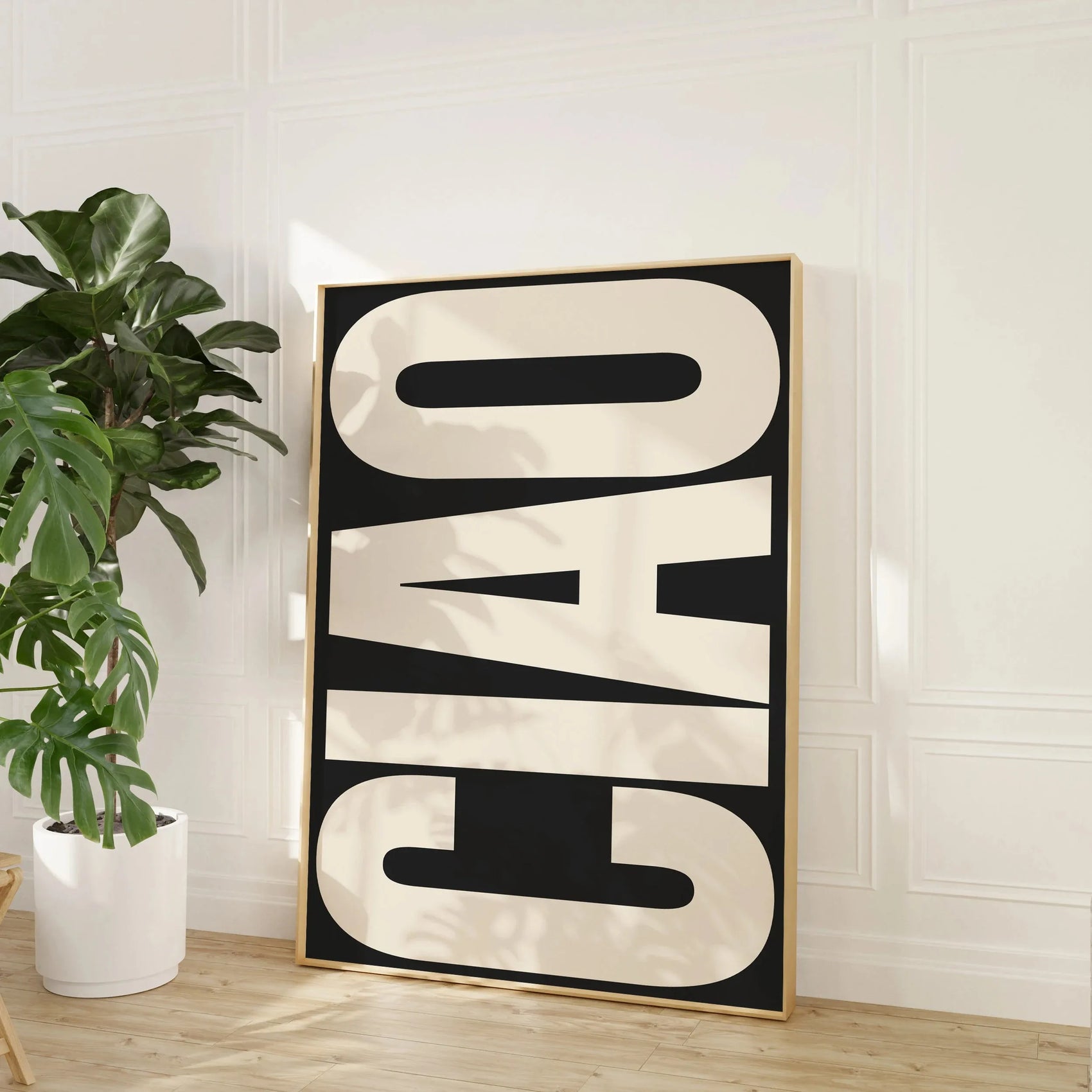 Decorative wall art with the word 'CIAO' in a modern interior setting.
