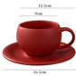 Red coffee cup and saucer with dimensions on a white background