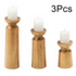 Three wooden candle holders with white candles on a white background, labeled &