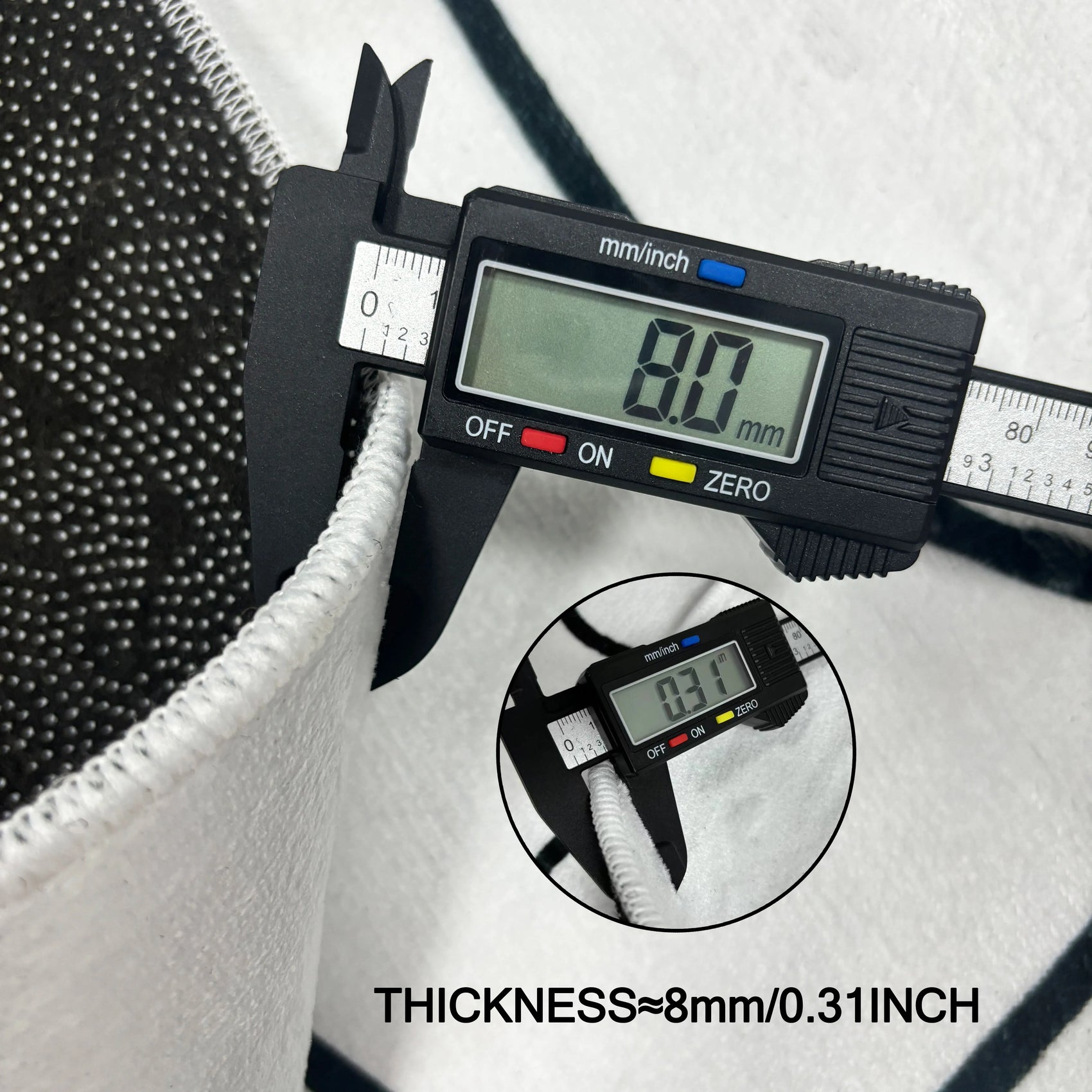 Digital caliper measuring the thickness of a material with a close-up inset showing the measurement.
